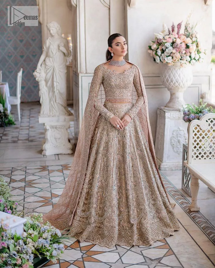 Carry the style that is your dream on your Nikah day with this classy article! A beautiful blouse in nude ivory colour is a perfect choice to pair with Lehenga. The blouse choli is emblazoned with silver embroidery and floral designs. Hand-crafted details of tilla, dabka, kora, Kundan and crystals make this choli a ravishing masterpiece. The boat shape neckline is a perfect choice to make this article super amazing. Further, the following blouse is maintain a balancing look of the bride with its full sleeves. It is handsomely systemized with a scalloped lehenga that is heavily adorned to win everyone's hearts at the very first glance with its charm and elegance. Finish this article with a dupatta its surface sprayed with sequin and beautifully framed by a heavily embellished floral border that is a perfect choice