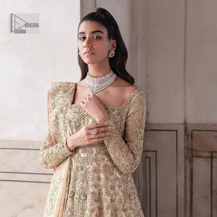 Ooze beauty and elegance in this simple yet amazing ensemble. This walima outfit in the off-white colour is a  magnificent look emblazoned with beautiful light golden embroidery which is further enhanced with tilla, dabka, kora, Kundan and the real magic of thread. The square neckline and full sleeves are unique in style and have classy look and perfect choice for the traditional bride. It is paired up with a lehenga which is adorned with beautiful embroidery. Father, the lehenga has a back-train to make this outfit lovely. Complete this with a dupatta framed with four-sided borders and sequins sprayed all over to add extra glam to this masterpiece.