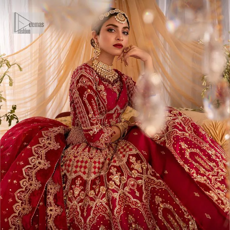 Enter the world of allurement with red shade, a gorgeous go-to dress for your big day to make you look classy and fabulous at the same time! A red organza base reception outfit is generously light golden embroidered with tilla, dabka, kora, Kundan and resham to form a beautifully composed lehenga, maxi and dupatta. The round neckline, three quarter sleeves make this outfit super amazing and charming. It is paired up with lehenga which is adorned with ting floral motifs. The can-can make this lehenga a dreamy real magic. Finish this look with dupatta, framed with a four sided borders. It is enhanced with sparkling of tiny floral motifs and sequins spray.