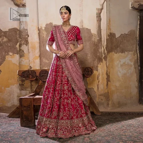 Blissful Pink! This ensemble is the epitome of grace. A shocking pink lehenga is heavily adorned with floral patterns. The