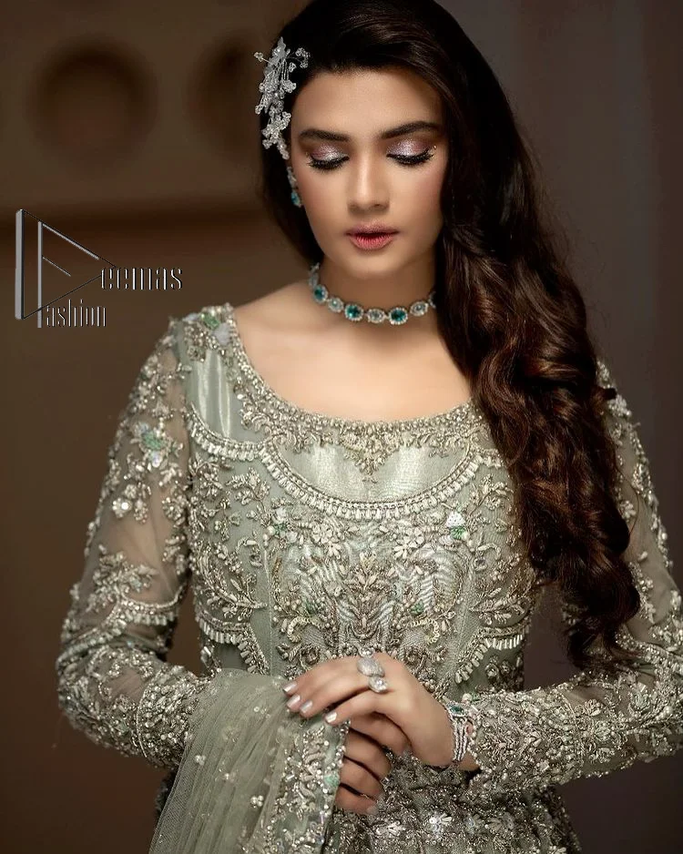 It was love at first swipe! Present this olive green back train maxi which is laboriously hand-rendered with silver embroidery to make you a pure soulful bride. It is enhanced with tilla, dabka, kora and Kundan. The illusion neckline adds more beauty to this walima wear when comes with full sleeves. The back train flare is made just for you to catch more and more love from your loved ones. Complete this walima wear with a dupatta in the same colour which is handsomely embellished with a four-sided heavy border and sequins sprayed all over to receive more love.