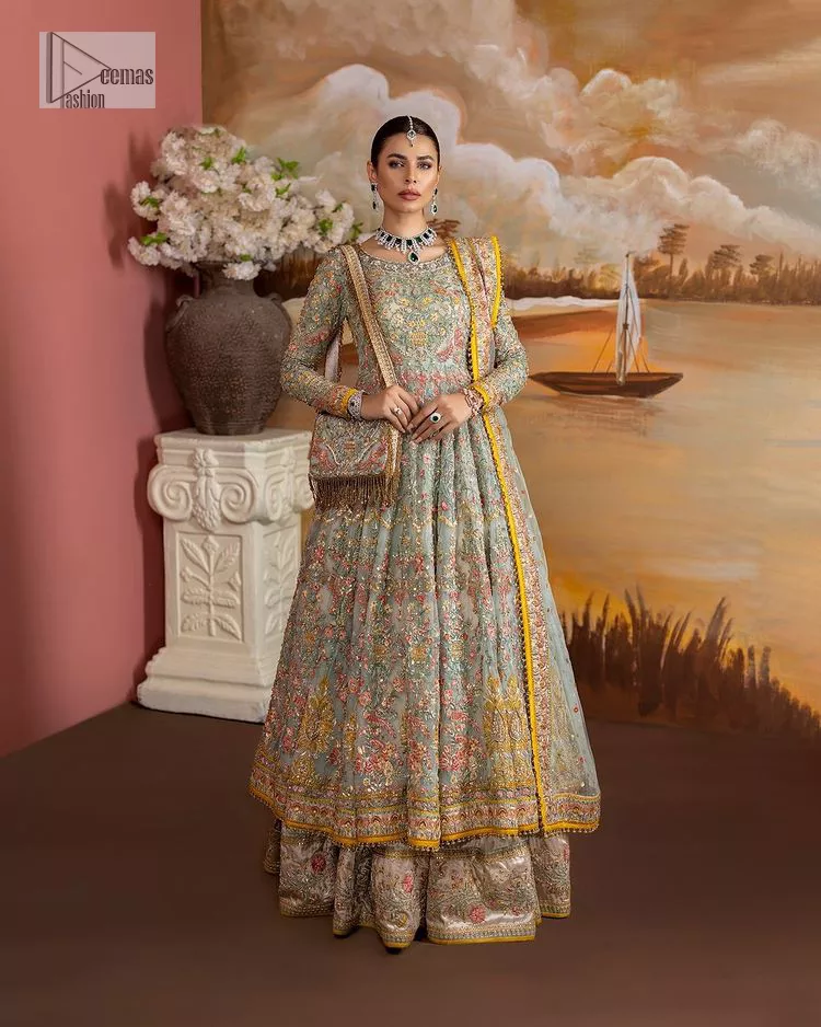 Enhance your beauty by dressing in magic. The most beautiful day of your life deserves an overall dome of embodiment, which is why you need an aqua-blue Anarkali to make you look stunning as a bride. The aqua blue, Anarkali and lehenga are hand-rendered in multiple colour embroidery and are further enhanced with pearls, nakshi, Sitara, tilla, kora, Zardozi and dabka.  The round neckline of the following Anarkali defines the beauty and charm of this unique article. Furthermore, the full sleeves are adorned with floral patterns. It is paired up with lehenga which is ornamented with a heavily embellished border to make this masterpiece unique. Complete this nikah wear with a dupatta adorned with four-sided embellished borders and tiny motifs sprinkled all over.