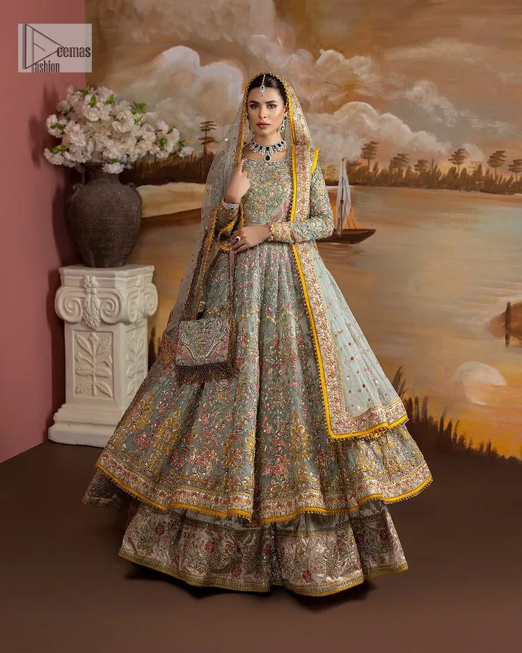 Enhance your beauty by dressing in magic. The most beautiful day of your life deserves an overall dome of embodiment, which is why you need an aqua-blue Anarkali to make you look stunning as a bride. The aqua blue, Anarkali and lehenga are hand-rendered in multiple colour embroidery and are further enhanced with pearls, nakshi, Sitara, tilla, kora, Zardozi and dabka.  The round neckline of the following Anarkali defines the beauty and charm of this unique article. Furthermore, the full sleeves are adorned with floral patterns. It is paired up with lehenga which is ornamented with a heavily embellished border to make this masterpiece unique. Complete this nikah wear with a dupatta adorned with four-sided embellished borders and tiny motifs sprinkled all over.