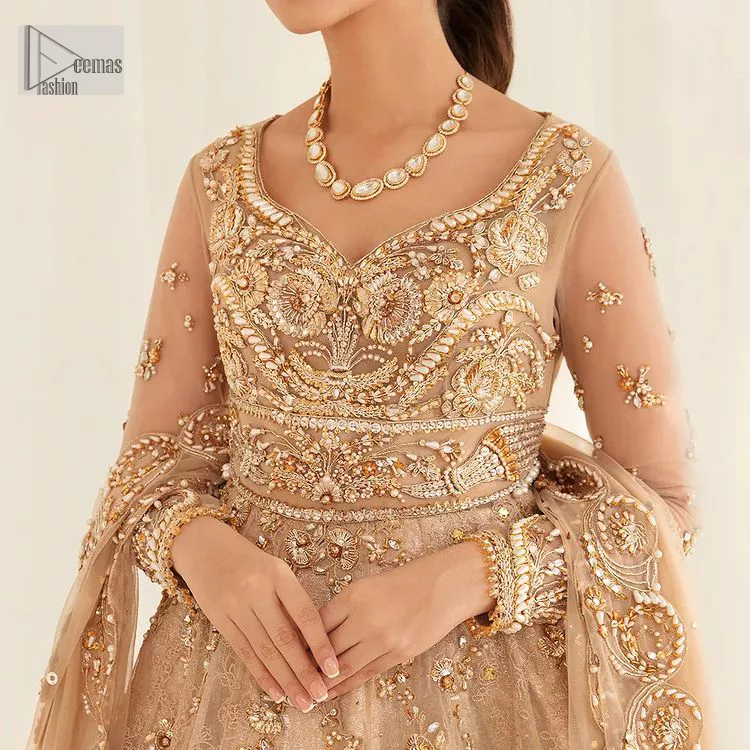 Presenting elegance personified glamorous formal nikah outfit. A heavenly-designed light golden maxi on an organza base serves as a canvas for spellbinding embellishments of antique gold, tilla, dabka, kora, Kundan and sequins. The sweetheart neckline makes this outfit unique and priceless. Furthermore, the following flawed maxi has three-quarter sleeves. It is paired with a plain lehenga and a dupatta in the same colour. The dupatta is adorned with carefully placed sequin spray and embellished four-sided borders for more calm and charm.
