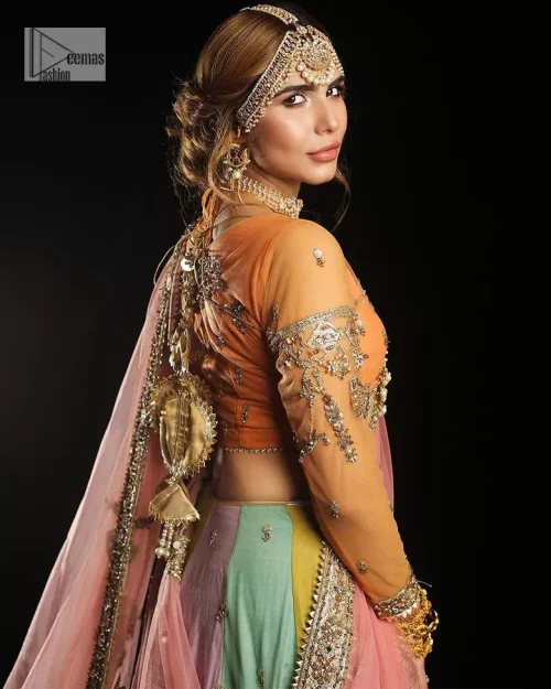 Fun colours, fresh you.  This breathtaking blouse in light orange colour is gracefully adorned with hand-crafted embellishments and lavish golden