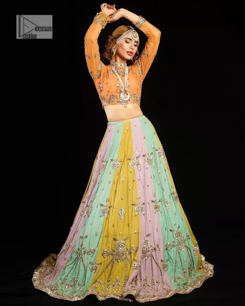 Fun colours, fresh you.  This breathtaking blouse in light orange colour is gracefully adorned with hand-crafted embellishments and lavish golden