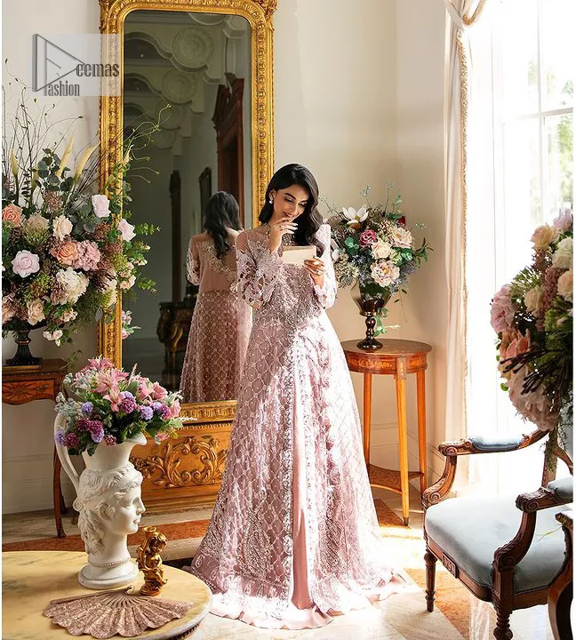 Incoming: that nikkah feeling with some flowers. Unique maxi for nikkah outfit in soft pink colour is embellished with silver pearls sequins, kora, dabka, tilla, Zardozi and Kundan work. Maxi Sleeves are fully embellished with embroidery and are in floral patterns. The Jewel neckline also makes this masterpiece unique and charming. Maxi Hemline is decorated with embroidery on the border. Further, the front open style makes it a perfect choice to pair with the dupatta. It is organized with a plain lehenga to balance the overall outfit. Complete this article with a dupatta framed with four-sided embellished scalloped borders and sequins sprayed all over.