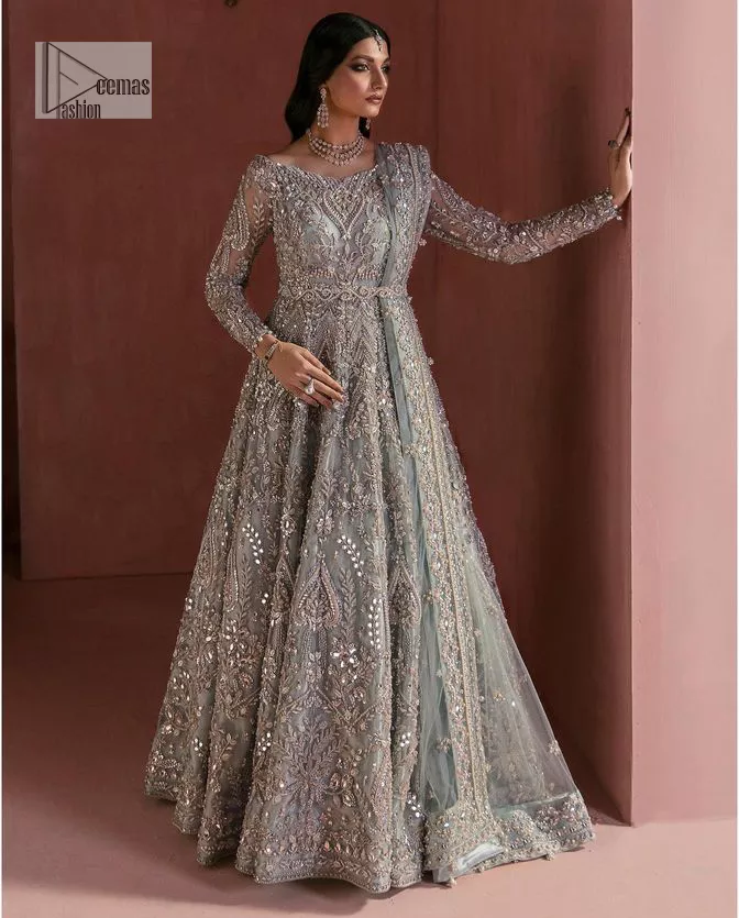 A timelessly classic and hot Nikah wear. DeemasFashion presents the flared maxi in grey colour which is heavily adorned with silver embroidery which is prominent with tilla, dabka, Kora, Kundan and the details of crystals. The boat shape neckline gives a super glamorous touch to the outfit. in addition to this, the floral patterns on full sleeves make this article lovely and romantic. A perfect outfit for an everlasting majestic look is paired up with a dupatta in the same colour framed with four-sided embellished borders and tiny floral motifs all over to give it a perfect royal look.