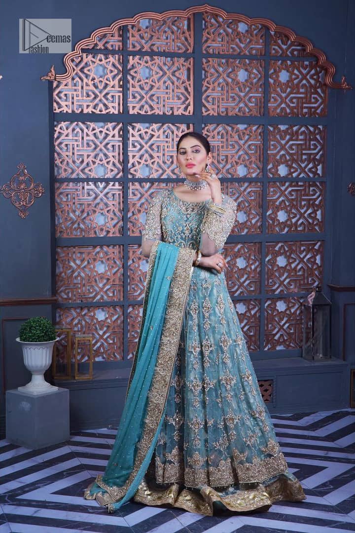 Bright colours are always a yes for a walima outfit. The embellished light blue maxi lehenga is an epitome of elegance and royalty that wins everyone's hearts at the very first glance with its charm and elegance. Hand-crafted details of golden and silver work on the maxi which is prominent with tilla, dabka, Kora, Kundan and the real magic of Zardozi give a glamorous touch to this masterpiece. The round neckline of the following maxi is the epitome of elegance. Further, the full sleeves are also decored with floral motifs. It is paired with a lehenga to balance the outfit details. Complete this outfit with a dupatta framed with four-sided borders and sequins sprayed all over.