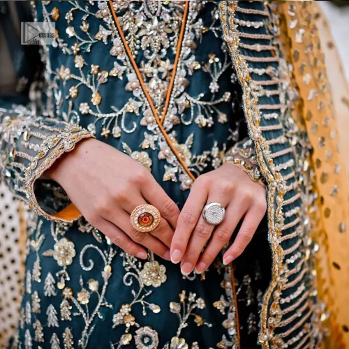 The long shirt is coordinated with an orange lehenga and dupatta.
