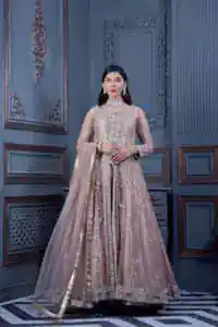Have style and warmth with this tea rose nikah outfit! The front open maxi is the magic of floral motifs with engaging embellishments on the jamawar fabric, making this an eye-catching ensemble. The following maxi is adorned with tilla, dabka, Kora, Kundan and the real magic of Zardozi. The timeless silhouette is crafted, with floral motifs. The silver embellishments give a glamorous touch to this exquisite attire. In addition to this, the full sleeves are also decorated with floral motifs to make this article bright and charming. The round neckline also adds beauty to the overall look. Finish this article with a dupatta adorned with a four-sided borders and sequins sprayed all over for a perfect and classy look.