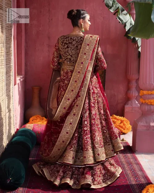Deep shades of this reception wear just to brighten up your days. The deep red frock is intricately emblazoned with