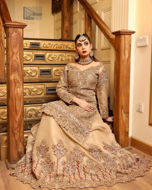 The antique embroidery delicately adorns the beige shirt, while the boat-shaped neckline and full sleeves create a refined, graceful silhouette.