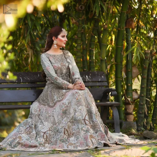 The lehenga flows gracefully, tailored from pure tissue fabric for a dreamy silhouette ornamented with silver and dark antique shades