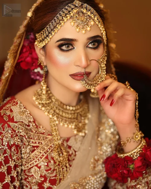 Can-Can layers, creates a dramatic silhouette, while the soft Fawn dupatta adds an air of refinement. The dress is adorned