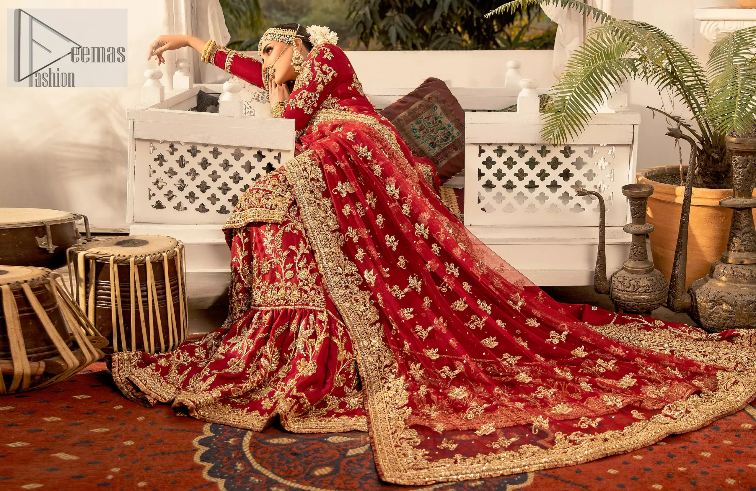 Your wedding day with the Red Long Shirt Back Train Farshi Lehenga, a stunning combination of traditional charm and modern grace.