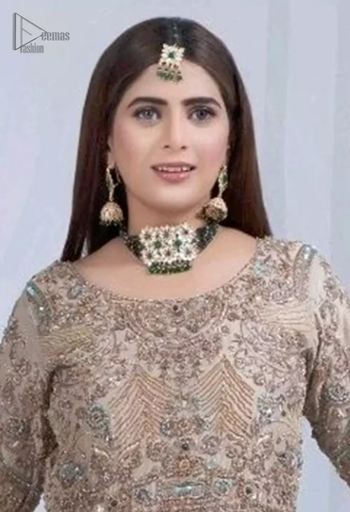 The round neckline and full sleeves offer a refined, classic appeal, while the subtle scalloped edges of the mint green