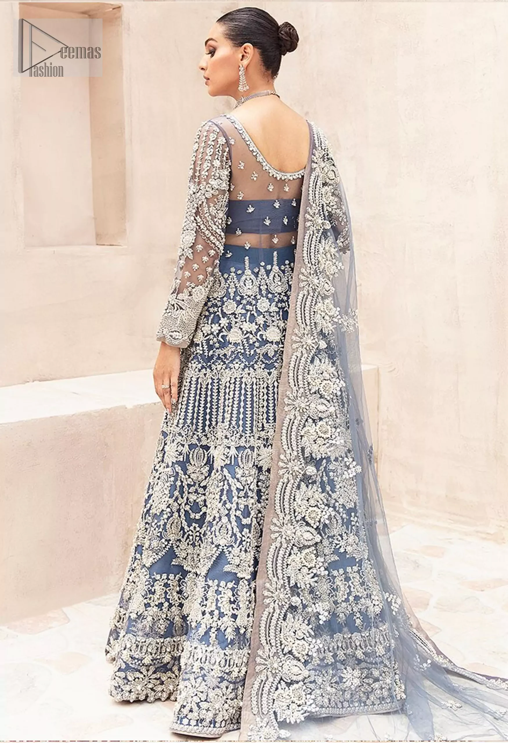 The soft, muted gray hue is beautifully enhanced by delicate silver and light gold embroidery, infusing the piece with ethereal elegance.