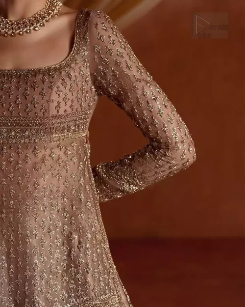 Geometric Pattern Focus: A detailed shot of the modern geometric patterns embroidered on the golden short shirt for a contemporary
