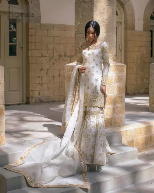 Round neckline and scalloped edges with golden embroidery on ivory raw silk shirt.