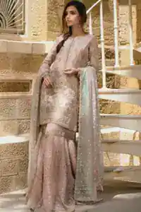 Wide flare and embroidered hemline of pastel pink katan organza gharara.