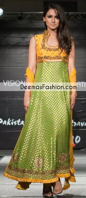 Mehndi green pure banarsi jamawar frock has a yellow bodice. The bodice and hemline have been embellished with dark antique embellishment. This sleeveless frock has been with dupatta and churidar pajama. Frill has been implemented on the hemline of the frock.